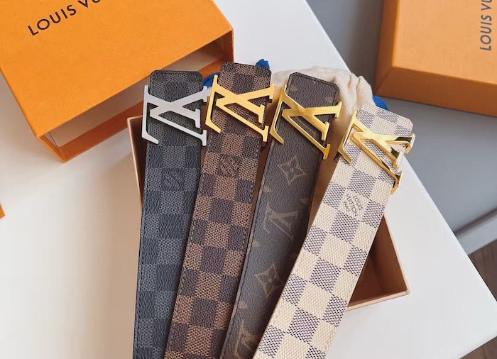 Detailed shot of the engraved LV buckle on a replica Initiales belt.